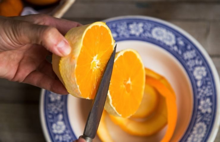 Person peels an orange