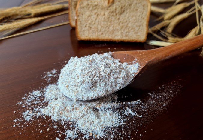 wooden spoon with whole grain flour